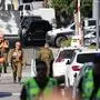 Members of the Israeli security forces walk along a street leading to Prime Minister Benjamin Netanyahu's residence in Caesarea on October 19, 2024. Netanyahu's office said a drone was launched toward his residence on October 19, after the military reported a drone from Lebanon had "hit a structure" in the central Israeli town. (Photo by Jack GUEZ / AFP)
