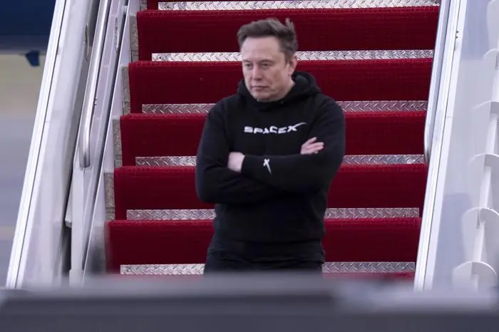 FILE - Elon Musk arrives on Air Force One at Philadelphia International Airport, March 22, 2025, in Philadelphia. (AP Photo/Chris Szagola, File)
