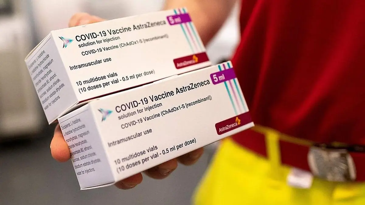 A health worker holds boxes with AstraZeneca's vaccines against the coronavirus SARS-CoV-2 on April 2, 2021 in Vienna, Austria, at the country's largest 'vaccination street' situated at the Austria Center. (Photo by JOE KLAMAR / AFP)