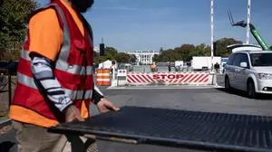 Workers install security fencing around the White House grounds in preparation for a rally with US Vice President and Democratic presidential nominee Kamala Harris on the Ellipse in Washington, DC, on October 28, 2024. (Photo by Brendan Smialowski / AFP)
