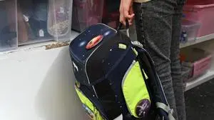 ABD0029_20250818 - WIEN - ÖSTERREICH: ++ THEMENBILD ++ Illustration zu den Themen Schule / Schulbeginn / Schulstart / Schulartikel / Bildung. Im Bild: Ein Kind hält einen Schulrucksack aufgenommen am Montag, 18. August 2025, im carla Mittersteig in Wien. - FOTO: APA/HELMUT FOHRINGER