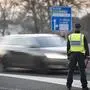 A motorist wearA Slovenian police officer controls traffic at the Slovenian-Italian border crossing near Nova Gorica, on March 11, 2020, after Slovenia's government announced it would close its border with Italy, hard hit by the outbreak of COVID-19, the new coronavirus. - Italy's neighbours Austria and Slovenia announced on March 10 Tuesday strict travel restrictions and other measures in the wake of similar moves by Rome to limit the spread of the new coronavirus. (Photo by Jure Makovec / AFP)