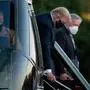 TOPSHOT - White House Chief of Staff Mark Meadows (R) watches as US President Donald Trump walks off Marine One while arriving at Walter Reed Medical Center in Bethesda, Maryland on October 2, 2020, after testing positive for covid-19. - President Donald Trump will spend the coming days in a military hospital just outside Washington to undergo treatment for the coronavirus, but will continue to work, the White House said Friday (Photo by Brendan Smialowski / AFP)