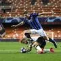 Atalanta's Robin Gosens, front, vies for the ball with Valencia's Daniel Wass during the Champions League round of 16 second leg soccer match between Valencia and Atalanta in Valencia, Spain, Tuesday March 10, 2020. The match is being in an empty stadium because of the coronavirus outbreak. (UEFA via AP)