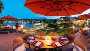 Eine Terrasse an einem See mit gedeckten Tischen