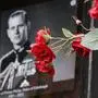 Flowers in front of a photograph of Britain's Prince Philip outside Windsor Castle in Windsor, England after the announcement regarding the death of Britain's Prince Philip, Friday, April 9, 2021. Buckingham Palace officials say Prince Philip, the husband of Queen Elizabeth II, has died. He was 99. Philip spent a month in hospital earlier this year before being released on March 16 to return to Windsor Castle. (AP Photo/Frank Augstein)