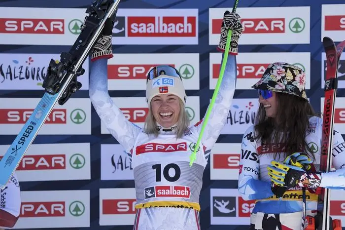 Norway's Kajsa Vickhoff Lie celebrates on the podium after taking joint third place with United States' Lauren Macuga, right, in a women's Super-G, at the Alpine Ski World Championships, in Saalbach-Hinterglemm, Austria, Thursday, Feb. 6, 2025. (AP Photo/Giovanni Auletta)