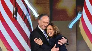 US Vice President and Democratic presidential candidate Kamala Harris hugs Second Gentleman Douglas Emhoff after speaking on the fourth and last day of the Democratic National Convention (DNC) at the United Center in Chicago, Illinois, on August 22, 2024. Vice President Kamala Harris will formally accept the party’s nomination for president today at the DNC which ran from August 19-22 in Chicago. (Photo by Mandel NGAN / AFP)