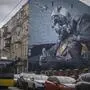 A mural depicts a Ukrainian pilot showing a thumbs-up sign on an apartment building wall in Kyiv, Ukraine, Friday, Jan. 19, 2024. The mural refers to a city legend of the Ghost of Kyiv, a flying ace who shot down six Russian pilots in the first 30 hours of the Russian invasion in February 2022 defending the sky over the capital. (AP Photo/Efrem Lukatsky)