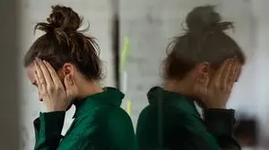 Young sad woman in office, having troubles.