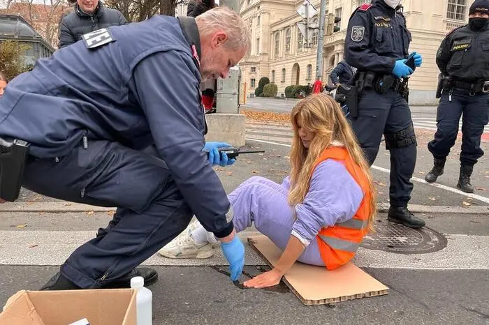 Erst mussten sie aber von der Polizei mit Lösungsmittel behandelt werden, weil die Aktivistinnen sich mit Superkleber auf den Asphalt geklebt hatten.