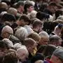 People observe two minutes of silence on the day of the State Funeral Service of Britain's Queen Elizabeth II, in London, Sept. 19, 2022. The Queen, who died aged 96 on Sept. 8, will be buried at Windsor alongside her late husband, Prince Philip, who died last year. (Alkis Konstantinidis/Pool Photo via AP)