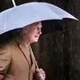 Britain King Charles III shelters under an umbrella outside York Minster to attend a short service for the unveiling of a statue of Queen Elizabeth II, and meet people from the Cathedral and the City of York, England, Wednesday, Nov. 9, 2022. (Danny Lawson/Pool Photo via AP)