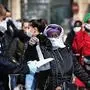 People don face masks outside the Institut Hospitalo-Universitaire Mediterranee Infection, in Marseille, southeastern France, before being screened for COVID-19, on March 28, 2020, on the twelfth day of a lockdown aimed at curbing the spread of COVID-19 (novel coronavirus) in France. - French doctor Didier Raoult, head of the institut Hospitalo-Universitaire Mediterranee Infection, announced in a statement on March 22 that anyone feeling feverish or simply anxious could ask to be tested at the clinic, a move against national instructions as normally tests in France are reserved for health care workers or people most at risk.. (Photo by Anne-Christine POUJOULAT / AFP)