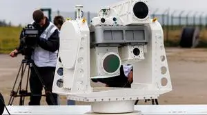 (FILES) A mobile sensor unit for drone detection using various camera systems is seen at the National Test Centre for Unmanned Aerial Systems of the German Aerospace Centre (DLR) as part of a presentation of the 'CUSTODIAN' programme for drone defence in Cochstedt, eastern Germany on October 8, 2025. Once holidaymakers took off from here, but today an ex-Soviet airfield is a testing ground for ways to take down the drones increasingly buzzing through German skies. Germany has been rattled by a spate of mysterious sightings of unmanned aerial vehicles (UAVs), believed to be from Russia, over military bases, industrial sites and an airport. But at the airstrip near the eastern city of Magdeburg, researchers of the German Aerospace Center (DLR) have been testing more subtle options to deal with potentially hostile drones. (Photo by JENS SCHLUETER / AFP)