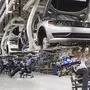 FILE - In this July 12, 2013, file photo, employees at the Volkswagen plant in Chattanooga, Tenn., work on the assembly of a Passat sedan. While the full effect on demand for Volkswagens non-diesel vehicles remains to be seen, some Tennessee officials fear for job prospects at the plant that currently employs 2,400, where the average hourly wage is about $21 and perks include reduced-cost leases on VW vehicles with free insurance coverage. (AP Photo/Erik Schelzig, File)