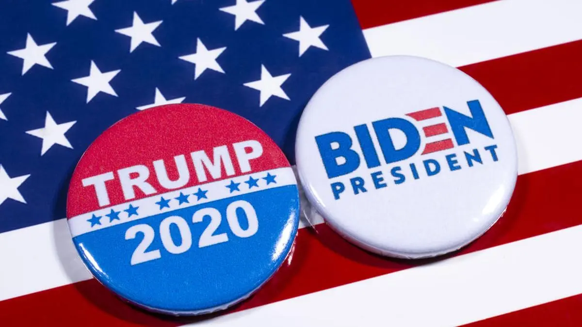 London, UK - May 5th 2020: Donald Trump and Joe Biden pin badges, pictured of the USA flag.  The two men will be battling eachother in the 2020 US Presidential Election.
