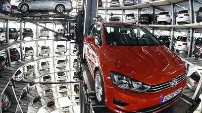 (FILES) This file photo taken on March 10, 2015 shows a VW Golf car (R) inside the so-called car towers of car manufacturer Volkswagen AG (VW) at the company's assembly plant in Wolfsburg, northern Germany.
Embattled automaker Volkswagen will hold talks Monday, August 22, 2016, with two component suppliers, in a bid to end a stand-off over car parts deliveries that has severely disrupted production at the German giant. / AFP PHOTO / TOBIAS SCHWARZ