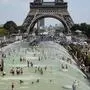 People cool off and sunbathe at the Trocadero Fountains in Paris, on July 25, 2019 as a new heatwave hits the French capital. - After all-time temperature records were smashed in Belgium, Germany and the Netherlands on July 24, Britain and the French capital Paris could on July 25 to see their highest ever temperatures. (Photo by Bertrand GUAY / AFP)