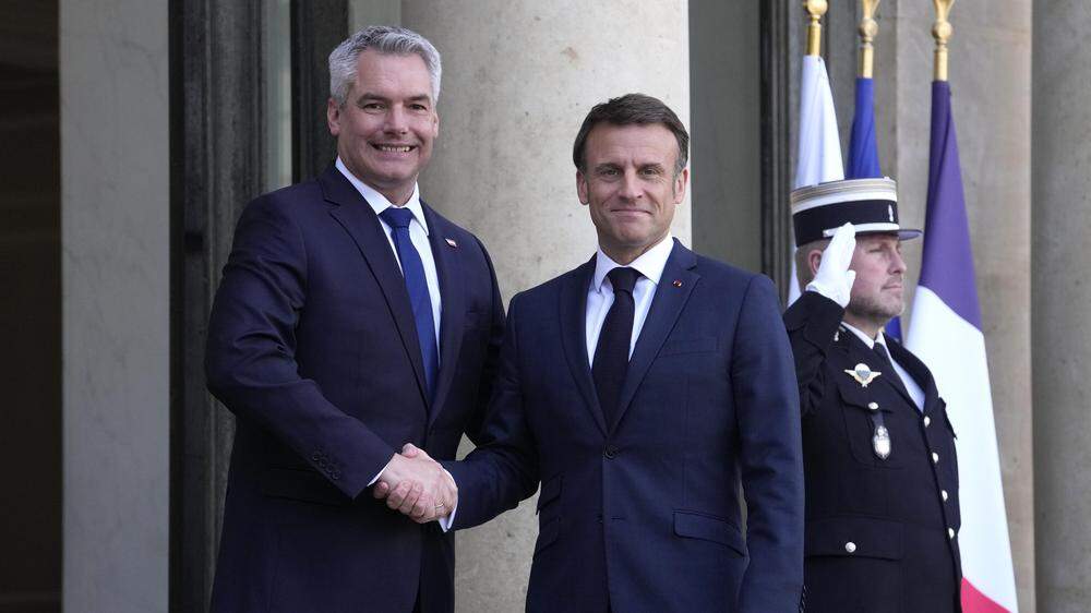 Der französische Präsident Emmanuel Macron (re.) begrüßt den österreichischen Bundeskanzler Karl Nehammer (li.) vor einem Treffen im Elysee-Palast in Paris.