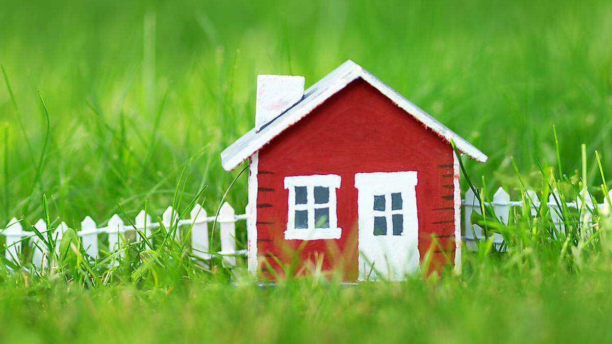 red wooden house on the grass