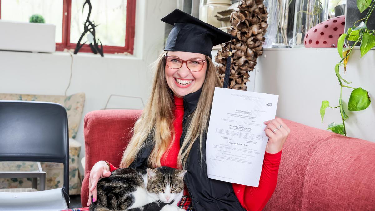 Bernadette de Roja mit dem Bachelorbescheid. Zur Feier des Tages setzte sie einen „Absolventenhut“ auf 