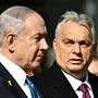 Hungary's Prime Minister Viktor Orban (R) and Israeli Prime Minister Benjamin Netanyahu review a military honor guard on April 3, 2025 in Budapest, Hungary. Israeli Prime Minister Benjamin Netanyahu arrived in Hungary in defiance of the International Criminal Court (ICC)'s arrest warrant against him over alleged war crimes in Gaza. Hungary has long-standing ties with Israel, and they been further bolstered up since the start of the war in Gaza, sparked by the Palestinian militant group Hamas's attack on October 7, 2023. (Photo by Attila KISBENEDEK / AFP)