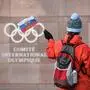 (FILES) In this file photograph taken on December 5, 2017, a supporter waves a Russian flag in front of the logo of the International Olympic Committee (IOC) at their headquarters in Pully near Lausanne. - The World Anti-Doping Agency on December 9, 2019, banned Russia from global sporting events including the 2020 Tokyo Olympics and the 2022 Beijing Winter Olympics after accusing Moscow of falsifying data from an anti-doping laboratory. (Photo by Fabrice COFFRINI / AFP)