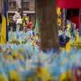 A child holds a balloon while looking at a memorial for soldiers who perished in the war in Kyiv, Ukraine, Thursday, March 14, 2024. (AP Photo/Vadim Ghirda)