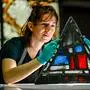 Employee of the Dombauhuette Elodie Schneider works on a stained glass window from Notre-Dame Cathedral in the Dombauhuette in Cologne on October 26, 2022. - Four windows from Notre Dame Cathedral in Paris, which was devastated by fire, have been restored at the Cologne Cathedral Building Lodge. (Photo by SASCHA SCHUERMANN / AFP)