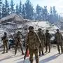 Turkish soldiers stand next to a destroyed building in Hatay, on February 11, 2023, after a 7.8-magnitude earthquake struck the country's southeast. - Rescuers pulled out children on February 10, 2023, from the rubble of the Turkey-Syria earthquake that struck on February 6, 2023, as the toll approached 23,000 and a winter freeze compounded the suffering for nearly one million people estimated to be in urgent need of food. (Photo by Yasin AKGUL / AFP)