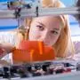 Young woman work with 3d printer