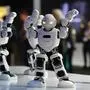 Alpha 1E robots dance at the booth of Ubtech during the IFA, the world's leading trade show for consumer electronics and home appliances, in Berlin on August 30, 2018. (Photo by Tobias SCHWARZ / AFP)