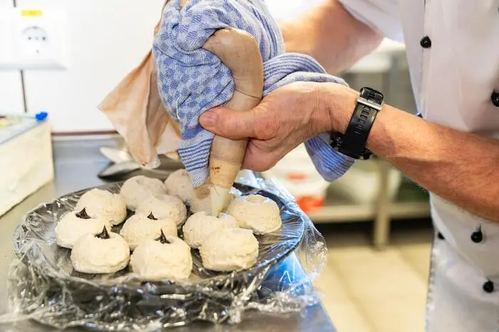 In die geformten Knödel mit dem Finger mittig ein kleines Loch formen, Powidl einfüllen