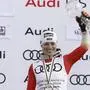 Switzerland's Lara Gut Behrami holds up the trophy for the alpine ski, women's World Cup giant slalom discipline, in Saalbach, Austria, Sunday, March 17, 2024. (AP Photo/Alessandro Trovati)
