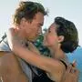 Arnold Schwarzenegger und Jamie Lee Curtis während einer Kussszene im Film True Lies | Arnold Schwarzenegger und Jamie Lee Curtis innig in True Lies (1994)