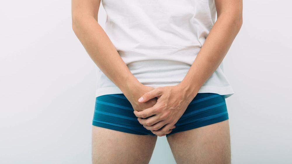 man wearing underpants holding genitals prostate problem. Men´s health, venereologist, sexual disease