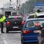 Slovak policemen check passengers at the Bratislava-Berg border crossing between Austria and Slovakia amidst the new coronavirus COVID-19 pandemic on May 23, 2020, - Slovak travelers patiently await launching of already delayed e-Karantena smart quarantine app to avoid mandatory isolation at the state's facilities. (Photo by JOE KLAMAR / AFP)