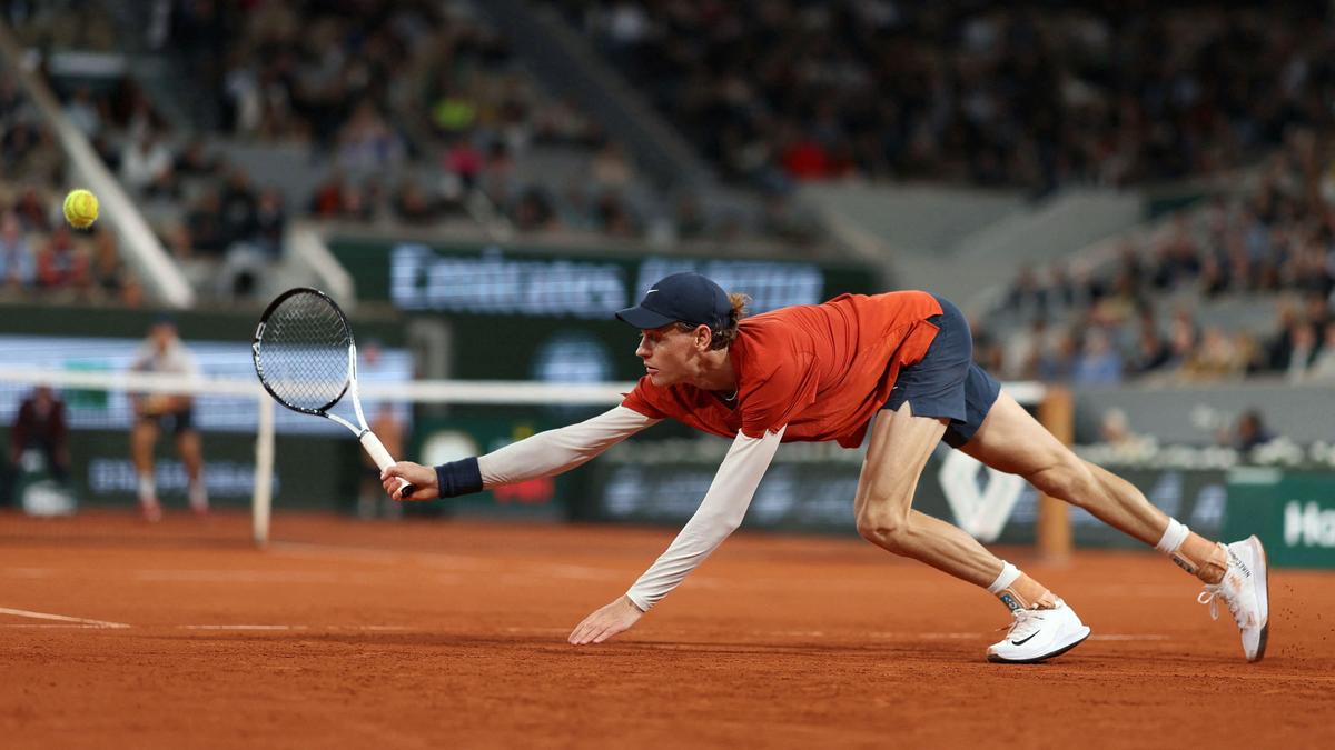 Italy's Jannik Sinner plays a backhand return to Russia's Pavel Kotov during their men's singles match on Court Philippe-Chatrier on day six of the French Open tennis tournament at the Roland Garros Complex in Paris on May 31, 2024. (Photo by Alain JOCARD / AFP)