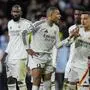Real Madrid's Kylian Mbappe, center, talks to an assistant referee after a penalty kick by Atletico Madrid's Julian Alvarez during a shootout at the end of the Champions League round of 16, second leg, soccer match between Atletico Madrid and Real Madrid at the Metropolitano stadium in Madrid, Spain, Wednesday, March 12, 2025. (AP Photo/Bernat Armangue)