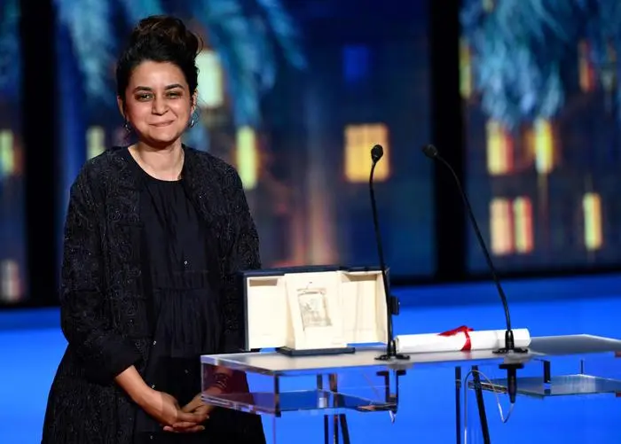 Indian director Payal Kapadia poses on stage after she was awarded with the Grand Prix for the film 