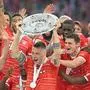 Bayern Munich players including Bayern Munich's German defender Niklas Suele (C) celebrate with the trophy after the German first division Bundesliga football match between FC Bayern Munich and VfB Stuttgart in Munich, southern Germany on May 8, 2022. (Photo by KERSTIN JOENSSON / AFP) / DFL REGULATIONS PROHIBIT ANY USE OF PHOTOGRAPHS AS IMAGE SEQUENCES AND/OR QUASI-VIDEO