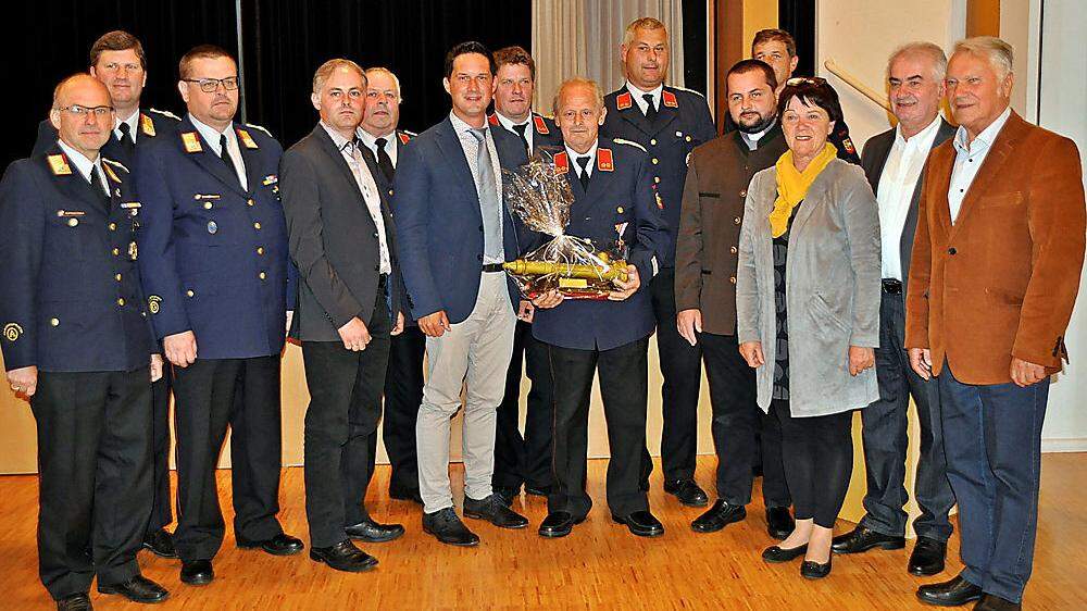 Der ausgezeichnete und geehrte Feuerwehrmann Karl Pfeifer umringt von Gratulanten