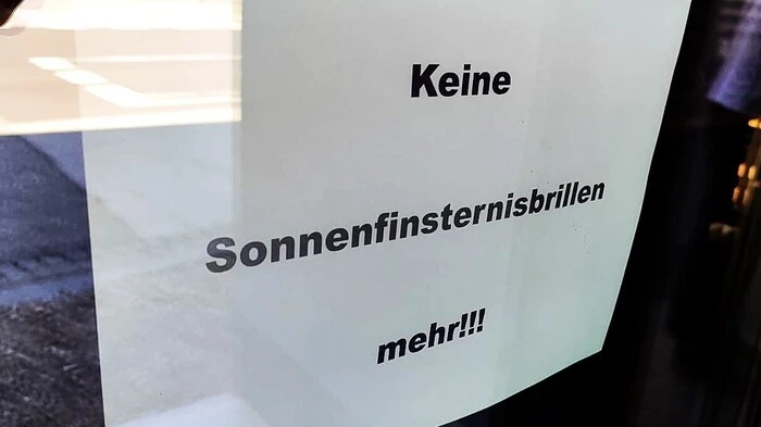 Zu sehen ist ein weißer Zettel mit der Aufschrift „Keine Sonnenfinsternisbrillen mehr!!“