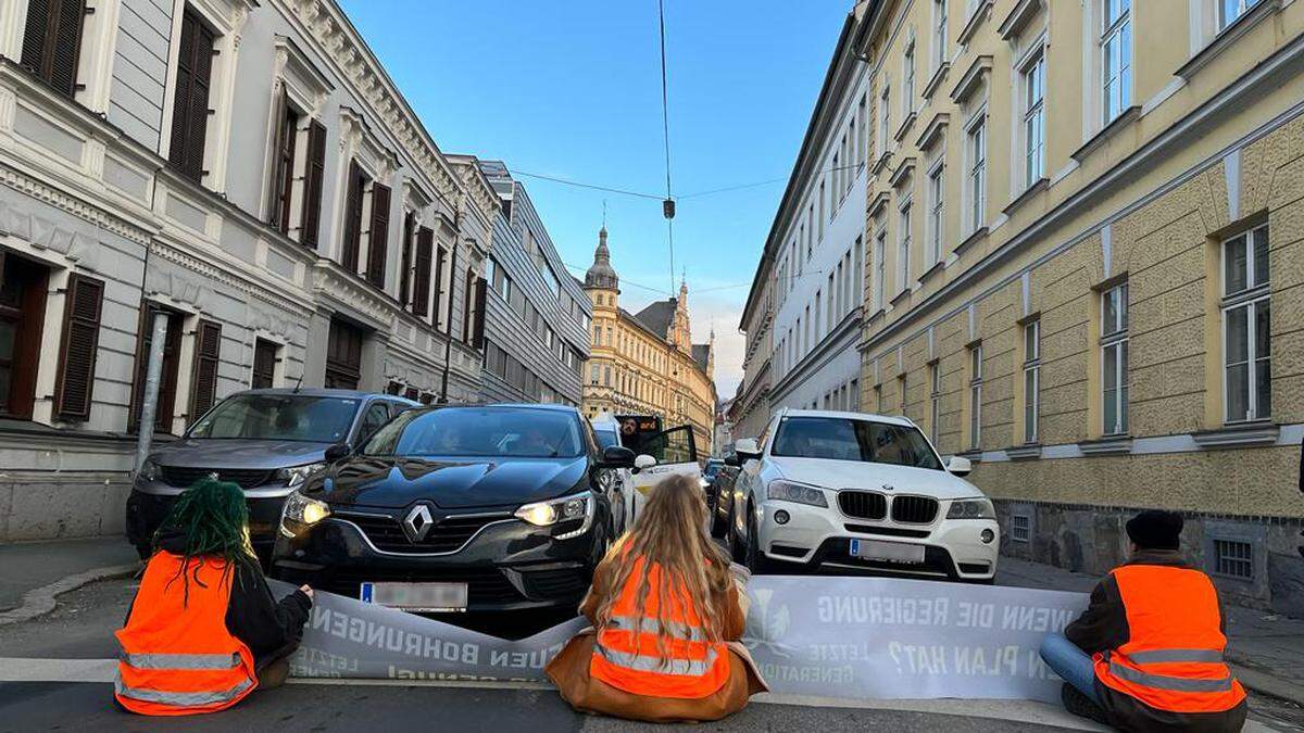 Zwei Aktivistinnen und ein Aktivist bremsten am Montag den Frühverkehr in der Grabenstraße in Graz aus
