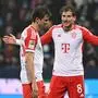 Bayern Munich's German midfielder #08 Leon Goretzka (R) and Bayern Munich's German forward #25 Thomas Mueller react during the German first division Bundesliga football match between VfL Bochum and FC Bayern Munich in Bochum, western Germany on February 18, 2024. (Photo by INA FASSBENDER / AFP) / DFL REGULATIONS PROHIBIT ANY USE OF PHOTOGRAPHS AS IMAGE SEQUENCES AND/OR QUASI-VIDEO