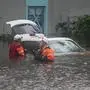 First responders in the water outside an apartment complex that was flooded from and overflowing creek due to Hurricane Milton on October 10, 2024 in Clearwater, Florida. At least four people were confirmed killed as a result of two tornadoes triggered by Hurricane Milton on the east coast of the US state of Florida, local authorities said Thursday. (Photo by Bryan R. SMITH / AFP)