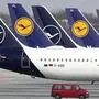 In this Thursday, March 26, 2020 file photo German Lufthansa planes sit parked in a line at the airport in Munich, Germany. Due to the coronavirus Lufthansa had to cancel most of its flights. (AP Photo/Matthias Schrader)