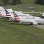 FILE - In this May 24, 2019, file photo, grounded Boeing 737 Max jets belonging to American Airlines are stored at Tulsa International Airport in Tulsa, Okla. American Airlines said Thursday, Jan. 2, 2020, it is negotiating with Boeing over compensation for the airline's grounded planes and will share some of the proceeds with its employees. (Tom Gilbert/Tulsa World via AP, File)