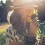 Girl smells sunflower in nature